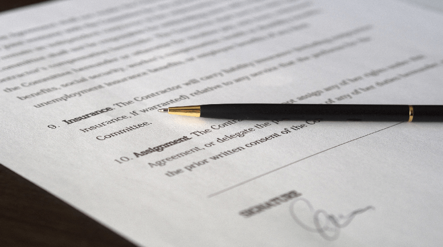 A pen laying on a contract.