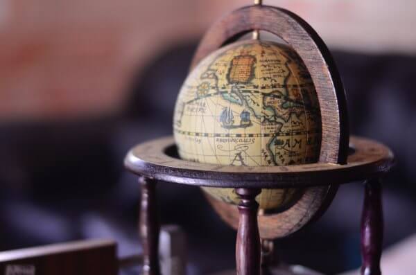wooden globe sitting on a desk