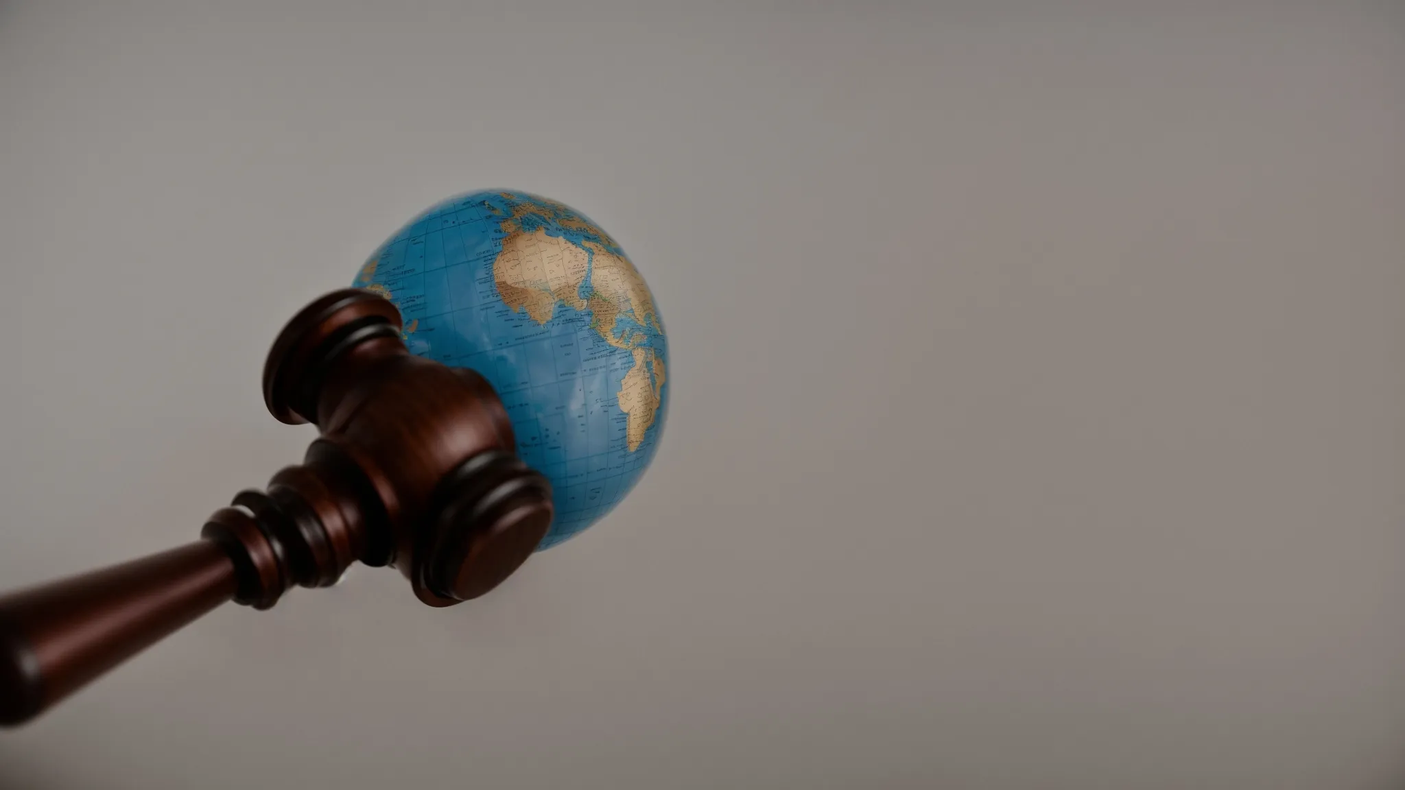 a gavel beside a globe to symbolize the balance and enforcement of international trade laws by isds.