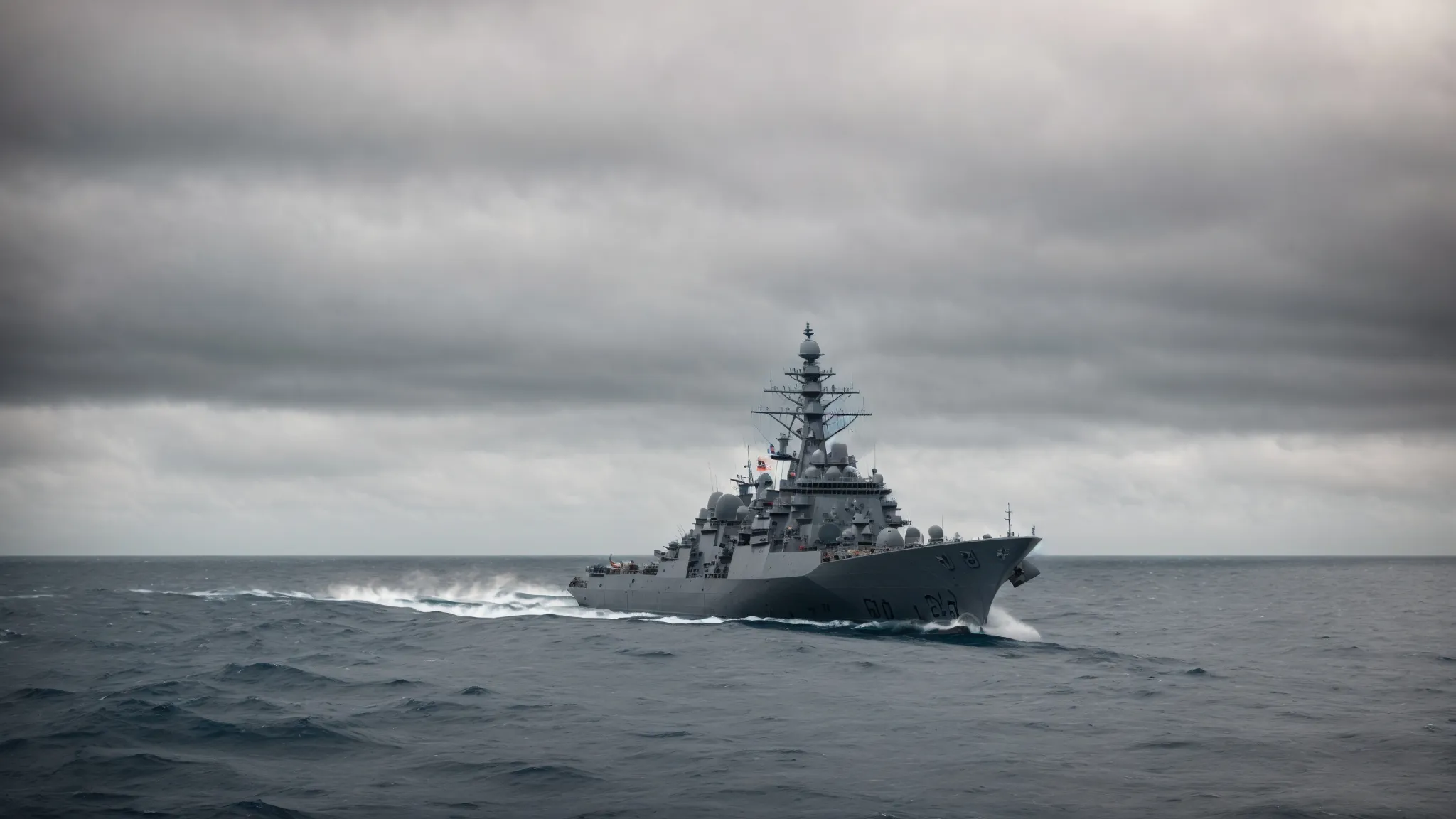 a naval warship patrols the open sea amidst a tense international maritime security situation.