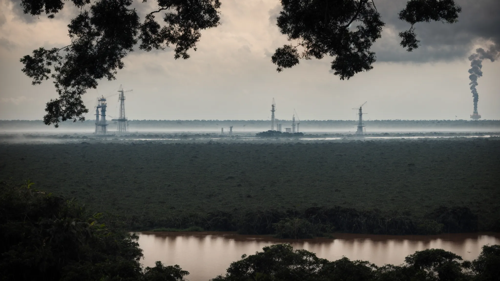 a vast stretch of oil-contaminated amazon rainforest with a distant view of an oil rig silhouetted against the sky.